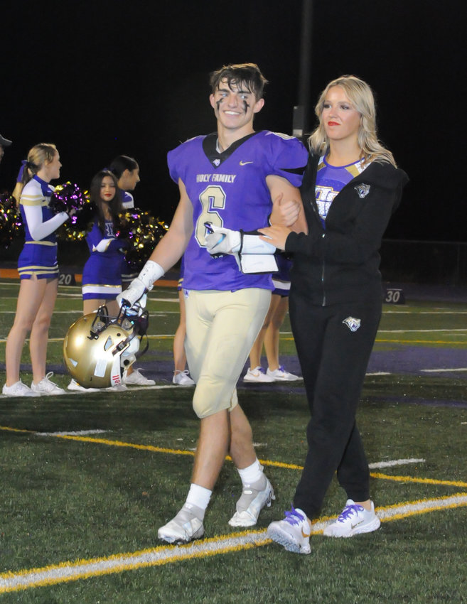 Holy Family junior homecoming royalty Dom Gabriel and Maggie Mischker are introduced during halftime ceremonies at Holy Family High School in Broomfield Sept. 30.